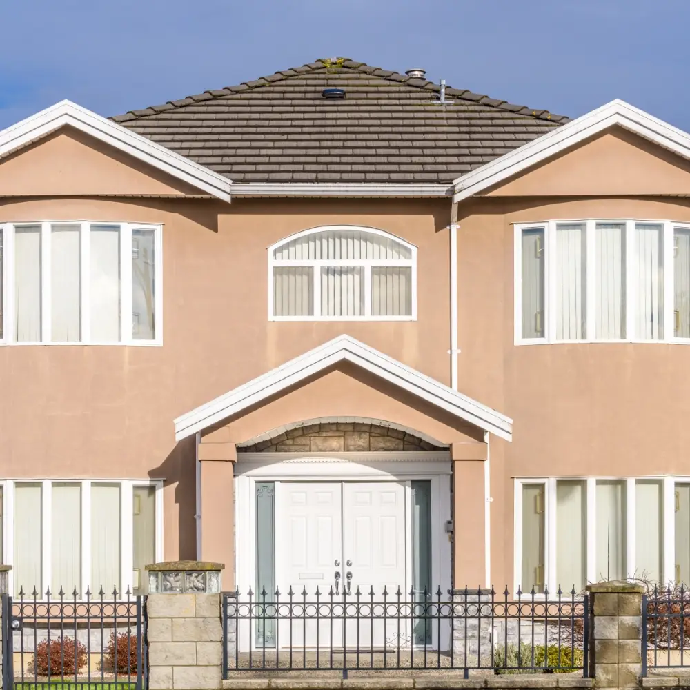 Large detached family home with gated entrance and front windows