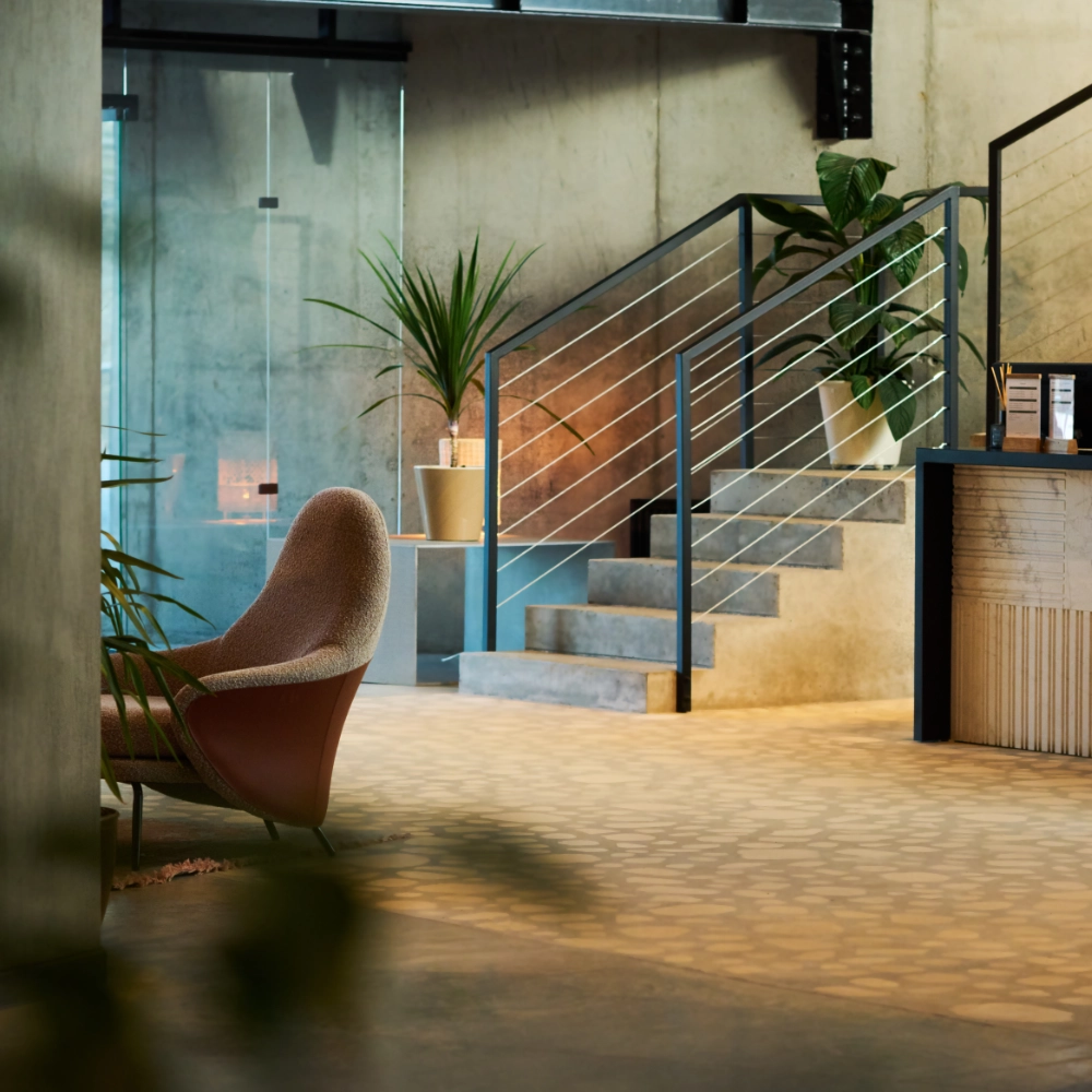 Modern office lobby with staircase, seating and glass partitions
